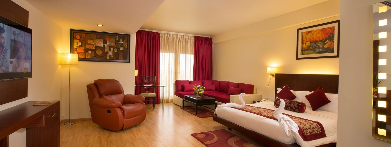 a view of Family Suite featuring a bed, a television and a recliner at Hotel Atithi - TGI Grand, Pondicherry