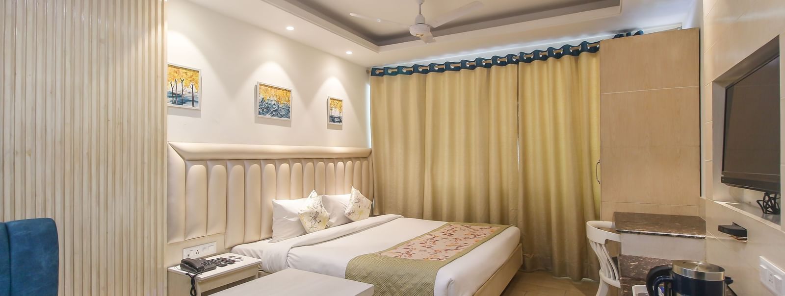 Well-furnished double room with seating area and writing desk at Hotel Diamond Plaza, Chandigarh