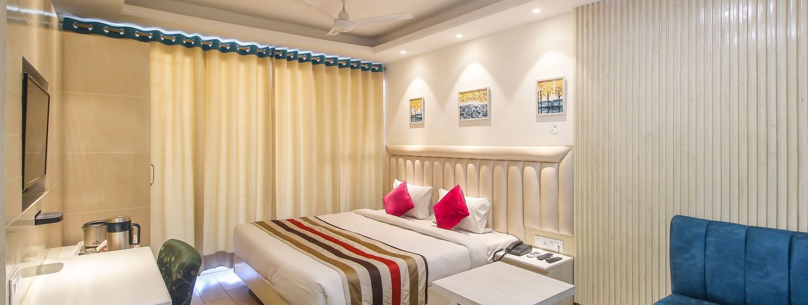 Spacious double room with bed and sofa at Hotel Diamond Plaza, Chandigarh