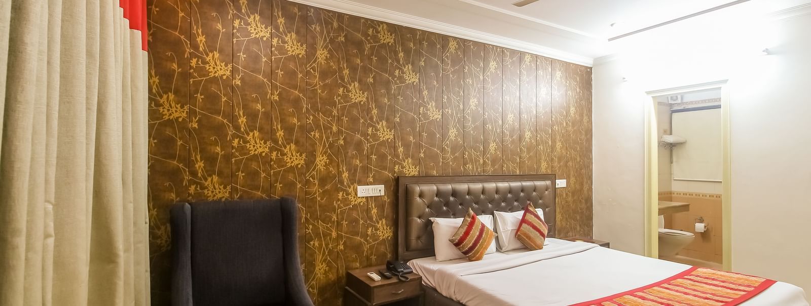 Spacious double room with armchairs and ambient lighting at Hotel Diamond Plaza, Chandigarh