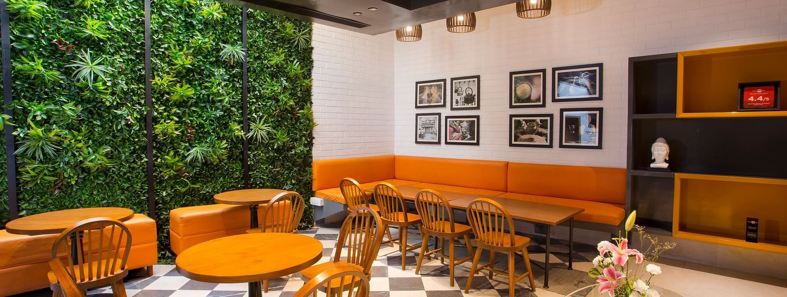 a room with large windows with views of trees and circular tables with chairs around them - Hotel Fountain Tree By TGI - JP Nagar, Bangalore