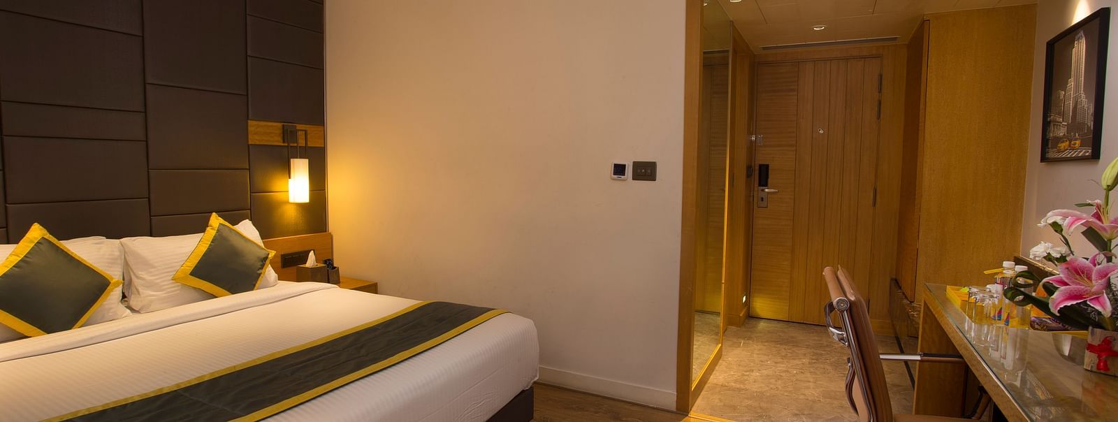 a bedroom with a large bed on the right side opposite to a work desk and chair  - Hotel Fountain Tree By TGI - JP Nagar, Bangalore