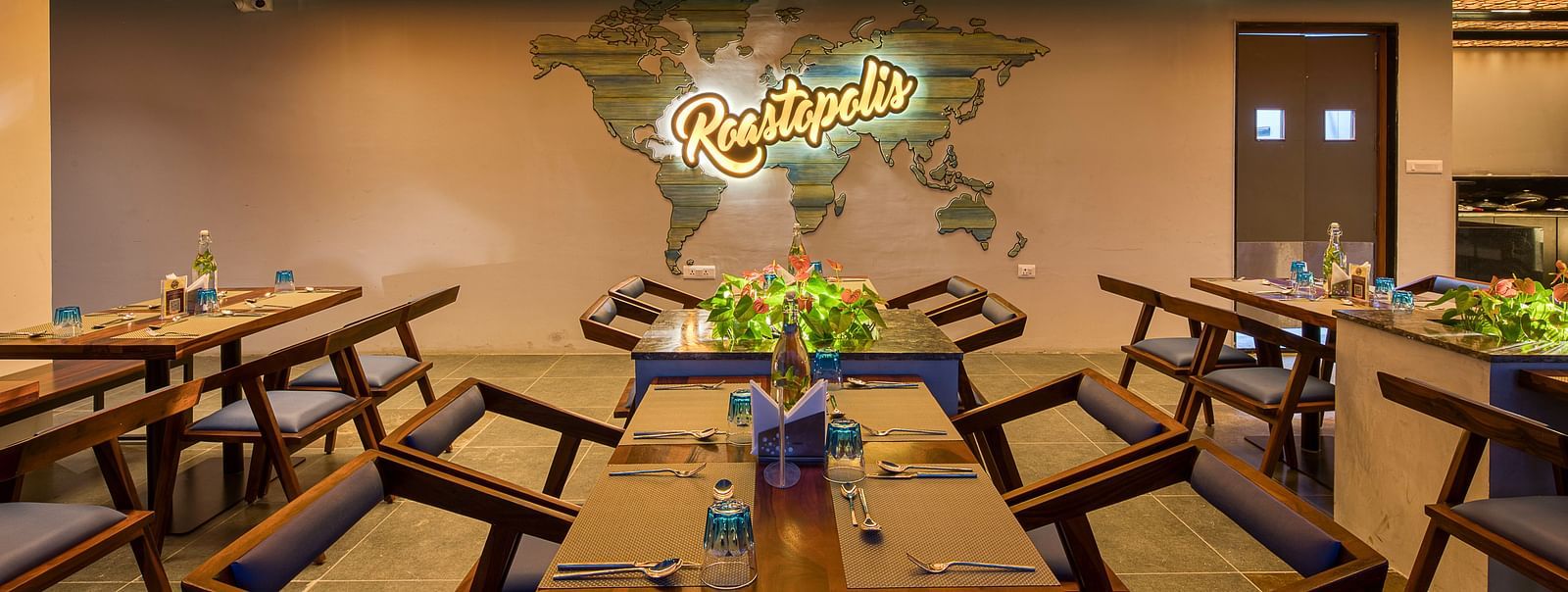 Interior of Roastopolis Restaurant at Le Foliage by TGI, Bangalore where tables and chairs are well aligned