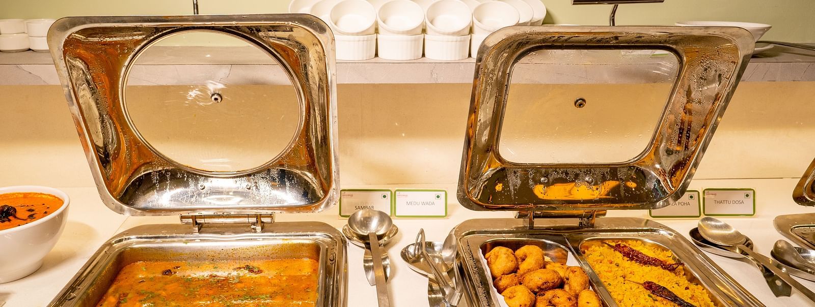 Chafing dishes with Indian cuisine on a buffet table - TGI Ameya Grand, Goa