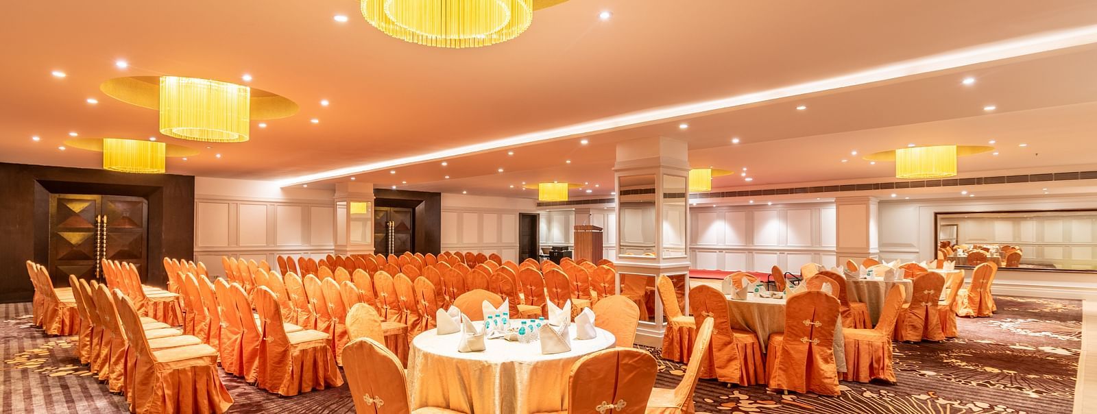 Banquet hall with round tables dressed in satin covers, perfect for a celebratory gathering