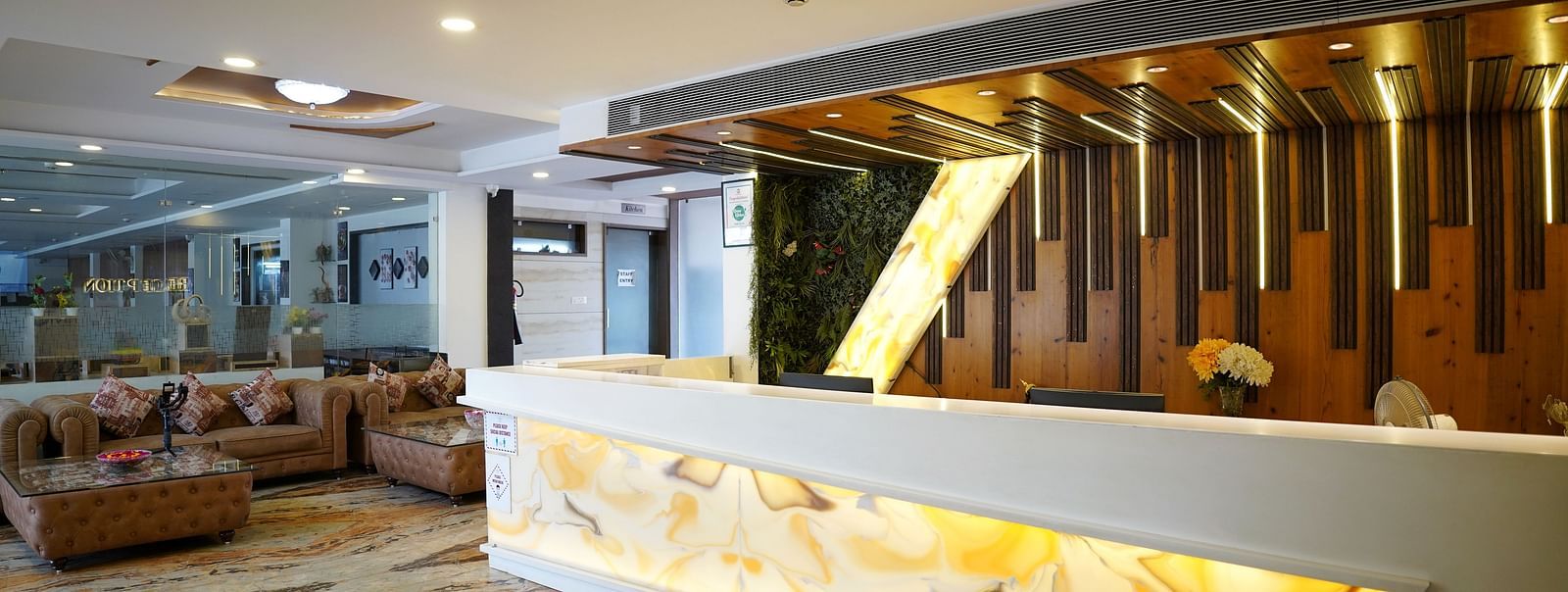 A spacious hotel lobby with modern decor and a reception desk - TGI Insignia, Bhopal