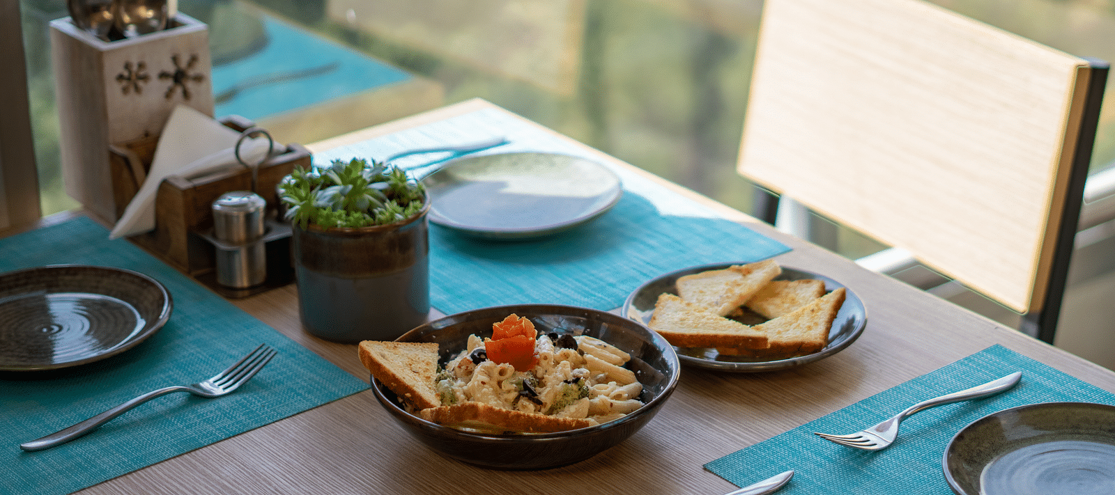 A dish placed on a table with cutlery arranged beside it at BluSalzz Escapade Resort, Lansdowne