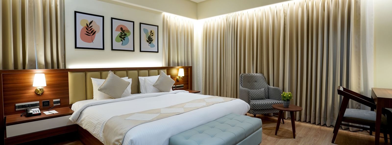 Full view of the Superior King Bed Room featuring a king size bed along with a cushioned bench in placed in front of it at M2 Square by Monday Premium.