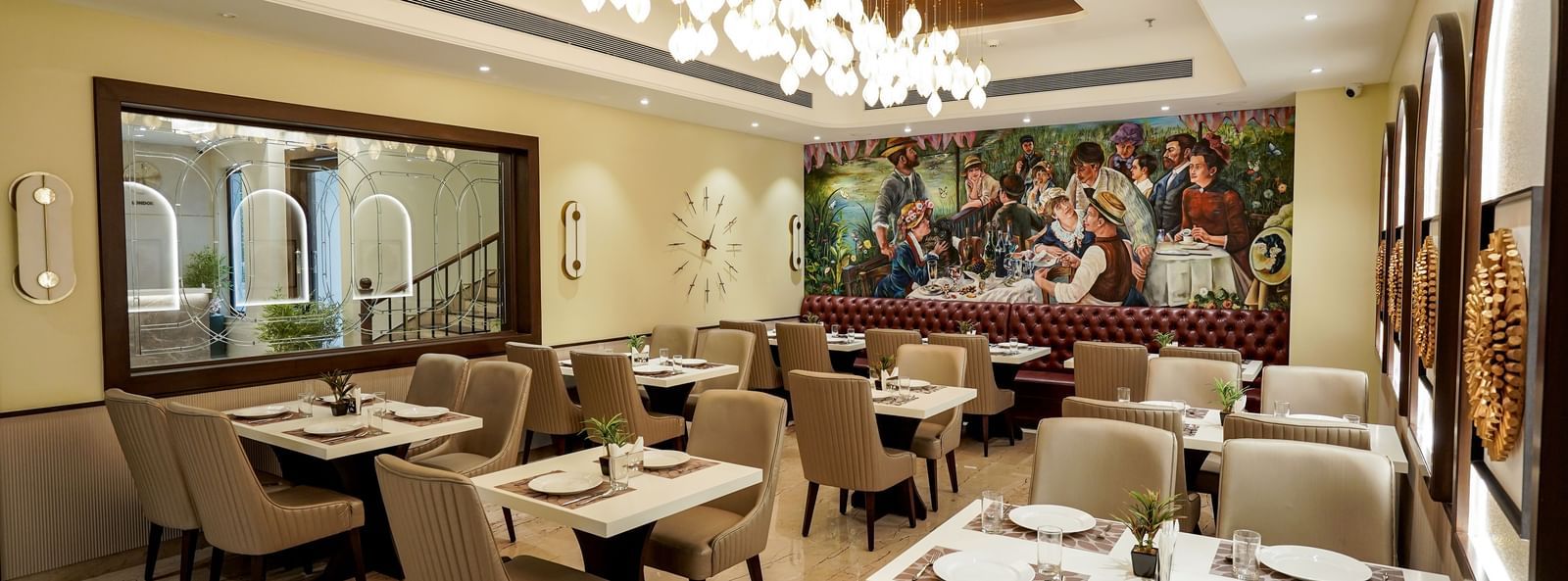 A wide angle shot of the Mosaic restaurant featuring a brightly lit dining area with modern interiors and well arranged tables at M2 Square by Monday Premium.