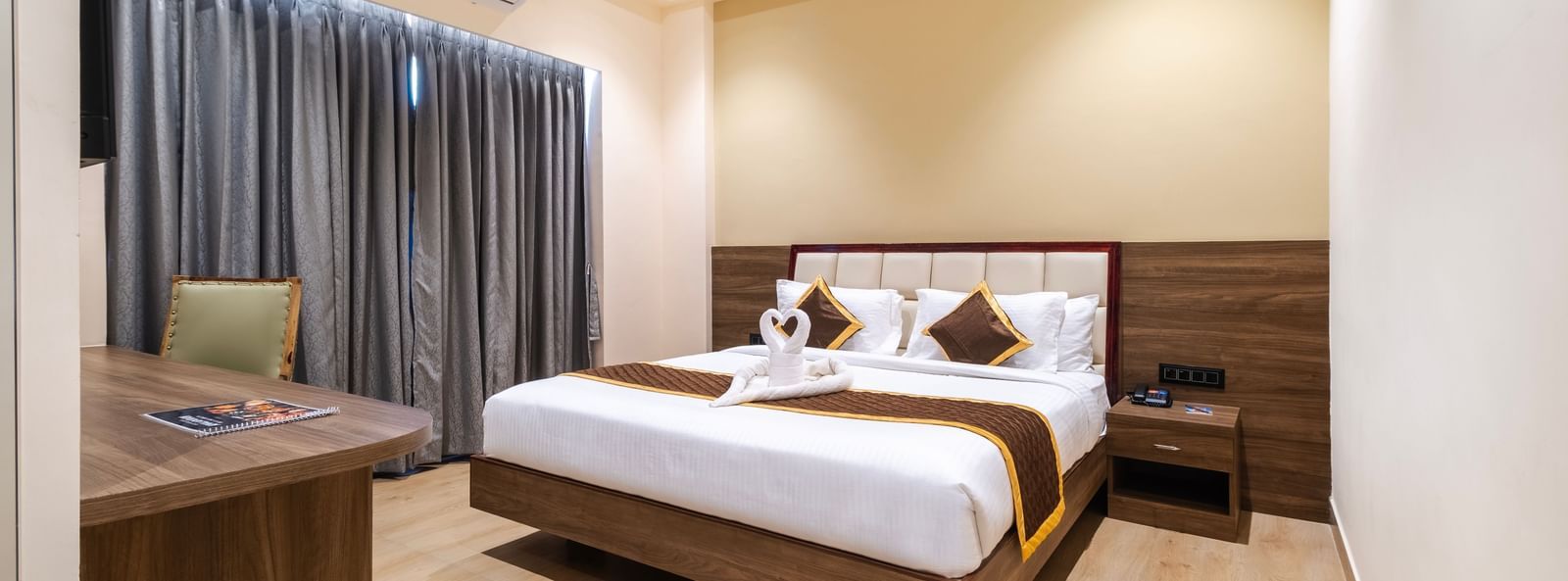 Spacious room at Monday Hotels Amalapuram Heights with elegant interiors and air-conditioning.