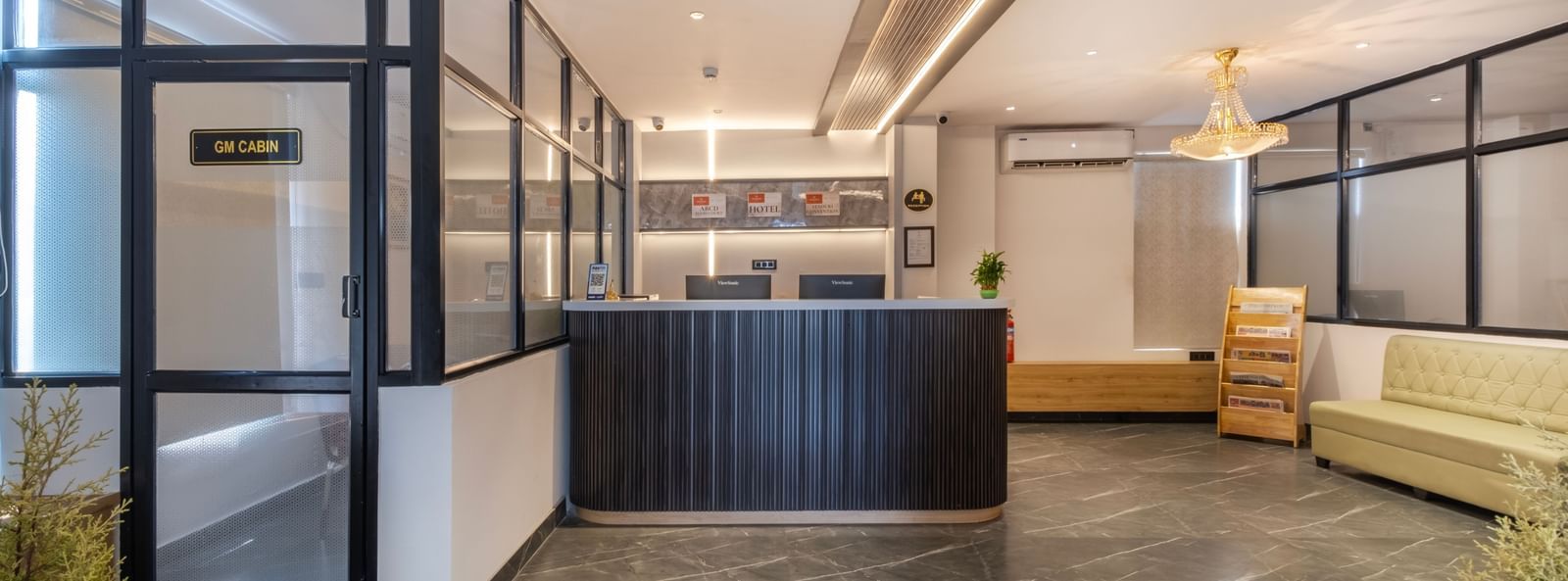Contemporary lobby with seating and reception desk at Monday Hotels Amalapuram Heights.