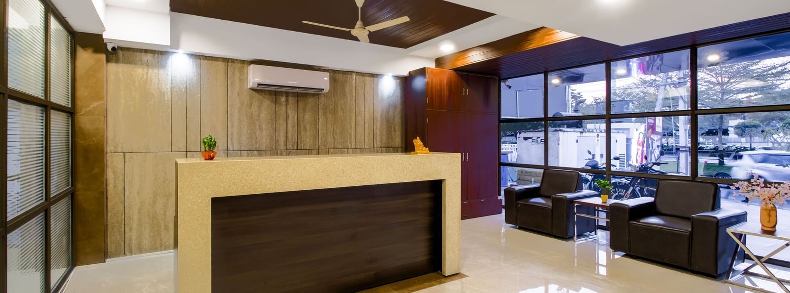 Reception desk with seating area polished flooring and contemporary design at Swarna's The Capital.