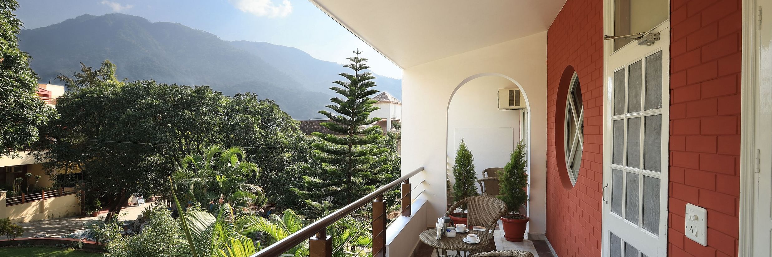 Super Deluxe Room balcony offers a view of the surrounding greenery - Lamrin Boutique Cottages Rishikesh