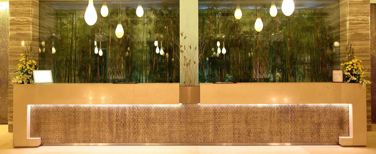 Image of the reception featuring unique lights and a front desk | Mirage Hotel