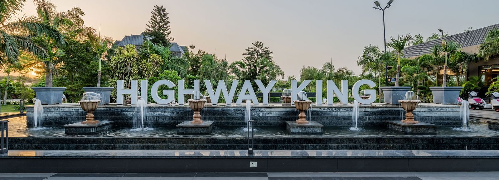 A shot of the signage of Highway king in the lawn of the hotel.