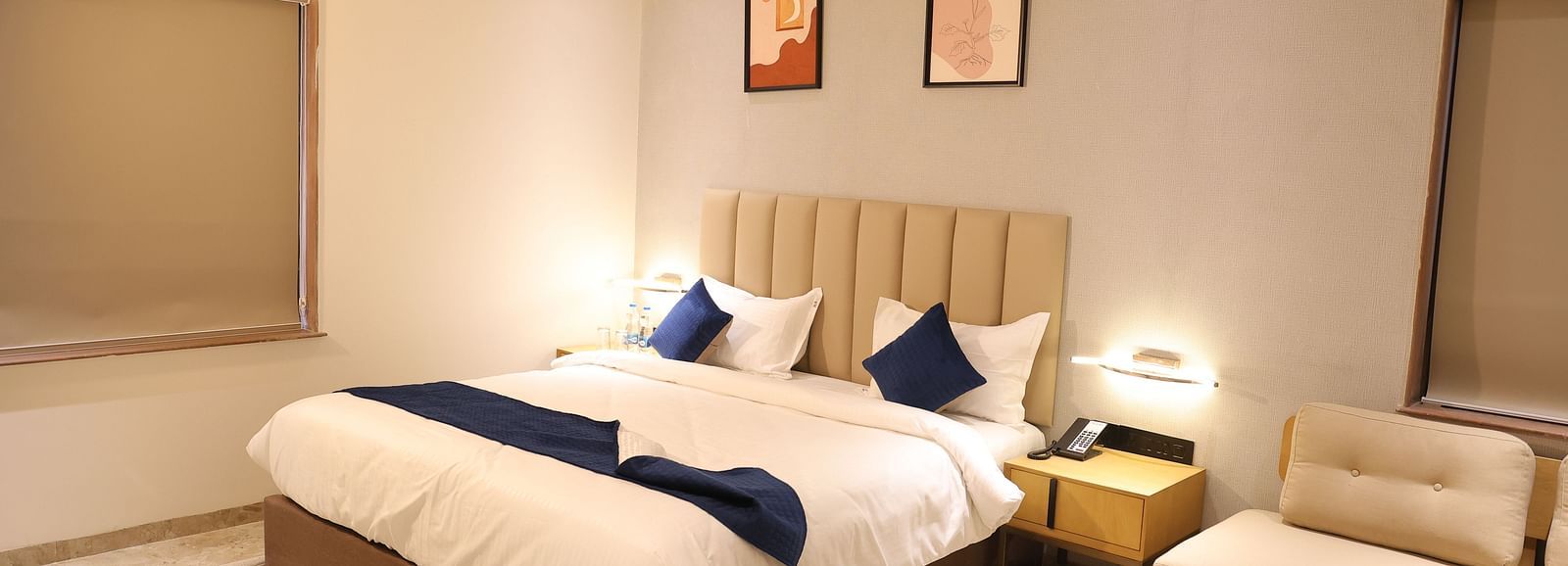 A luxurious Deluxe Room at Lords Eco inn Jamnagar Maheshwari Nagar showcasing a comfortable bed and contemporary furnishings.