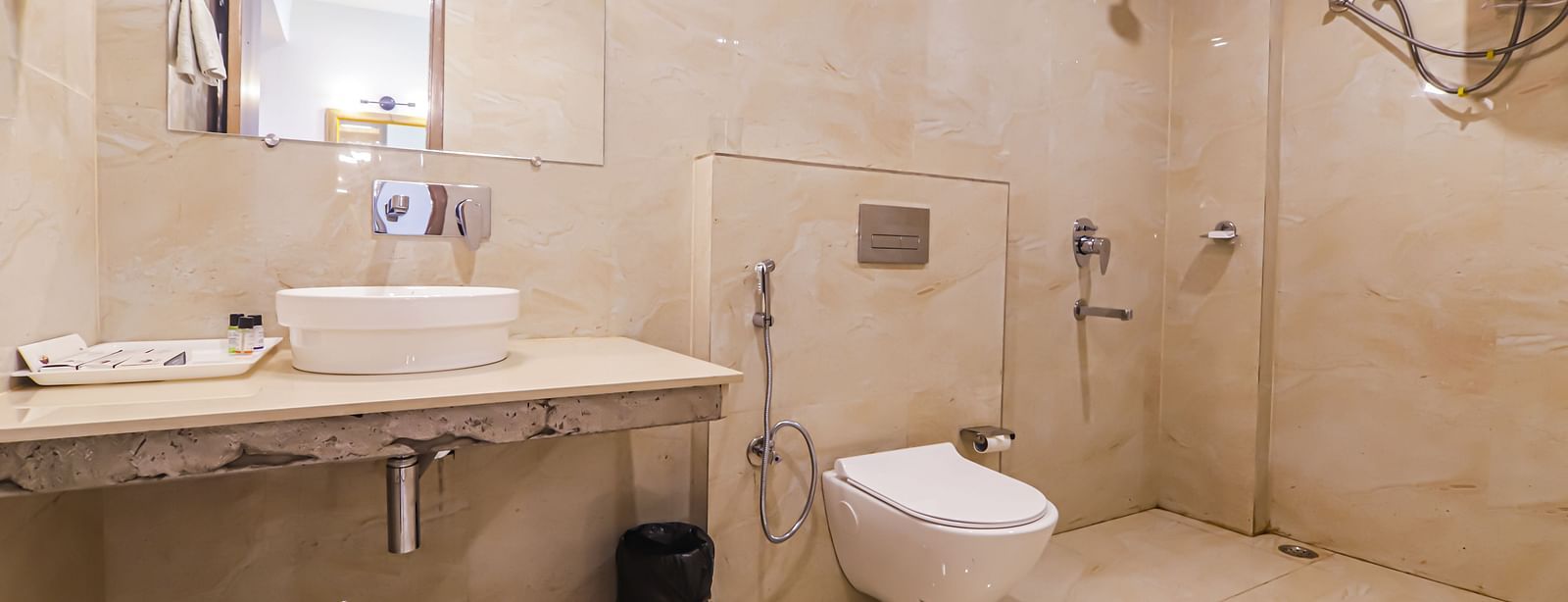 A bathroom at Vedikant Resorts The Mallard Corbett includes a sink, toilet, and shower area.