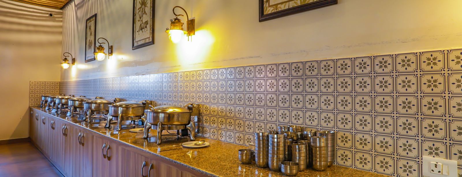 A buffet area with various food warmers and a long counter is visible in a dining space at Vedikant Resorts The Mallard Corbett.
