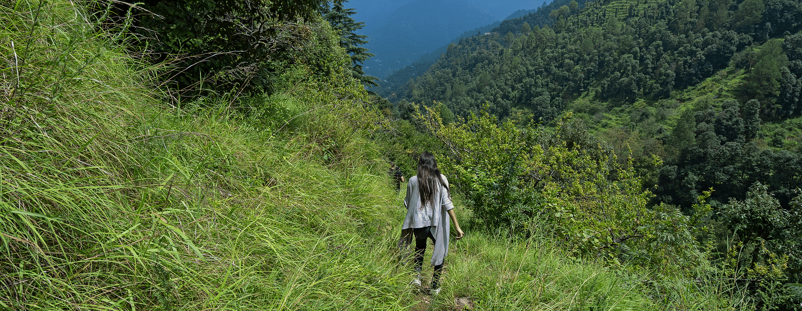 Image of a girl trekking on a mountain side at Ramgah