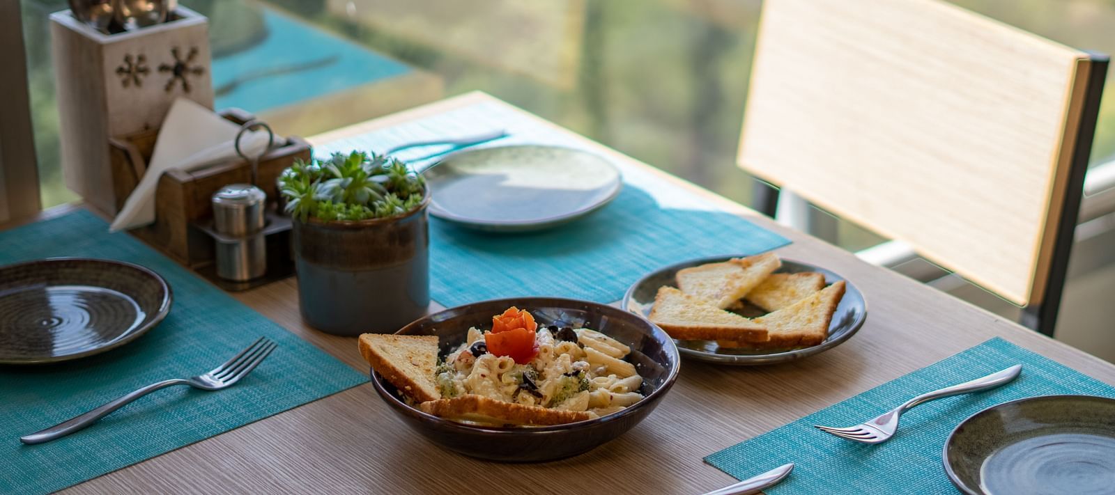 A dish placed on a table with cutlery arranged beside it at BluSalzz Escapade Resort, Lansdowne