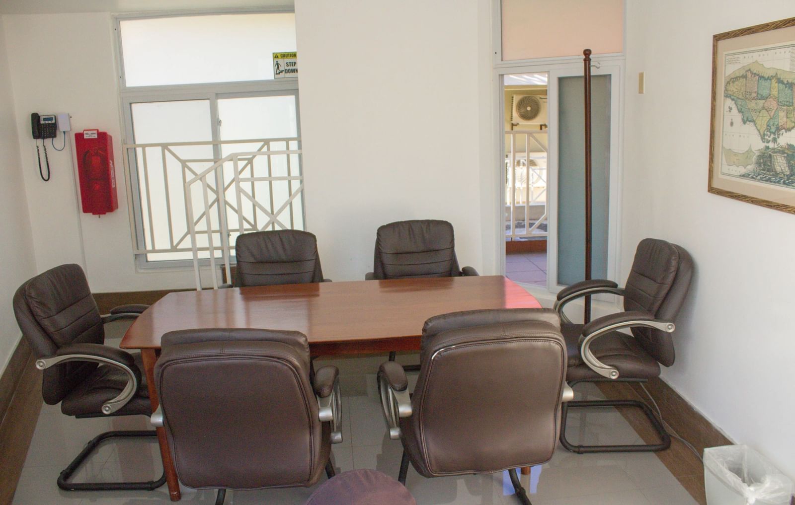 A conference room with a large table and chairs, set up for a meeting or discussion | Breakaway Room | Altamont Court, Jamaica