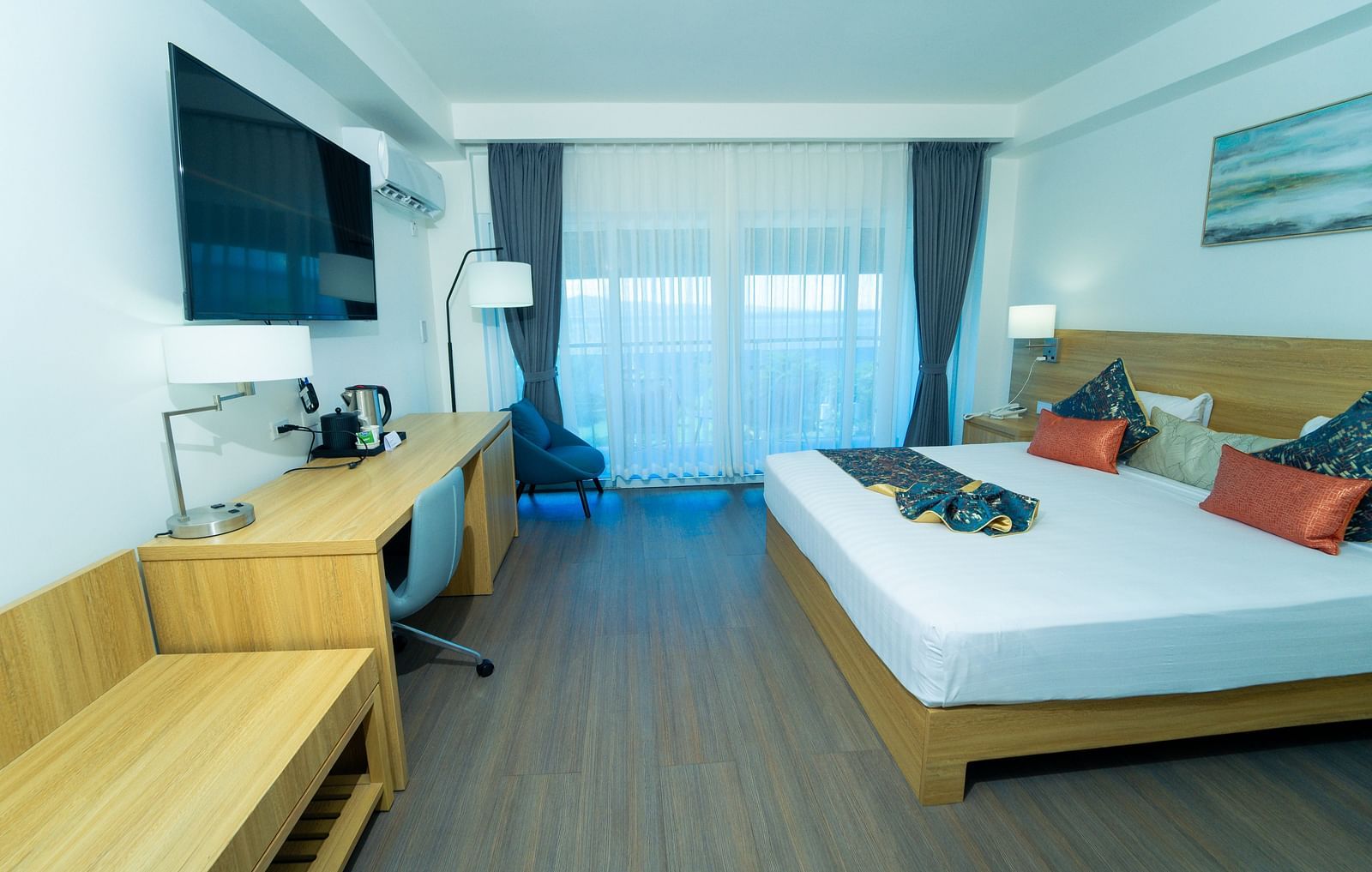 An image of a hotel room in Montego Bay with a king size bed and a wall mounted television - Hotel 39, Jamaica (Montego Bay)