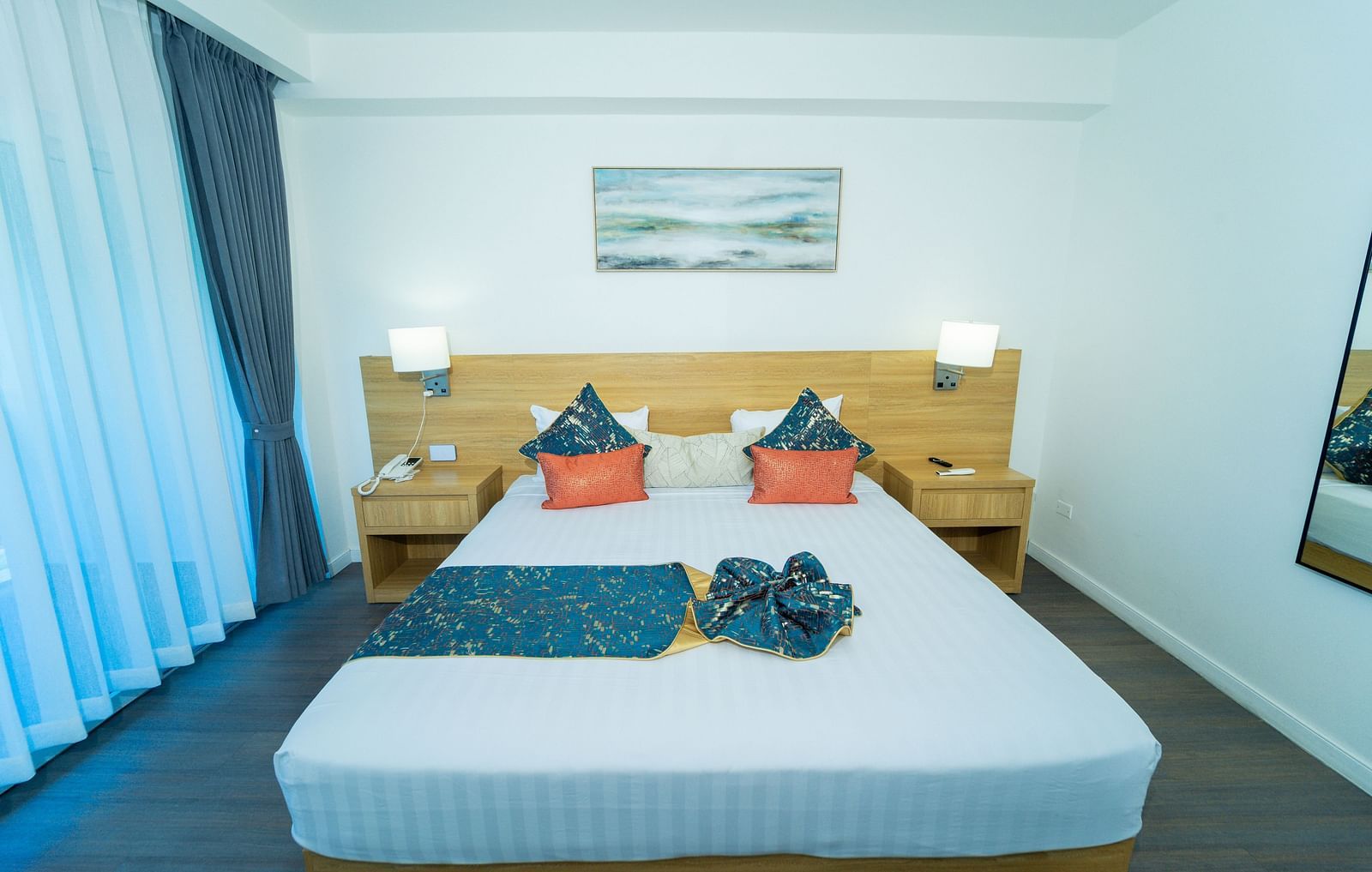 An image of a king size bed with night lamps placed on either side of it in our hotel room in Jamaica - Hotel 39, Jamaica (Montego Bay)