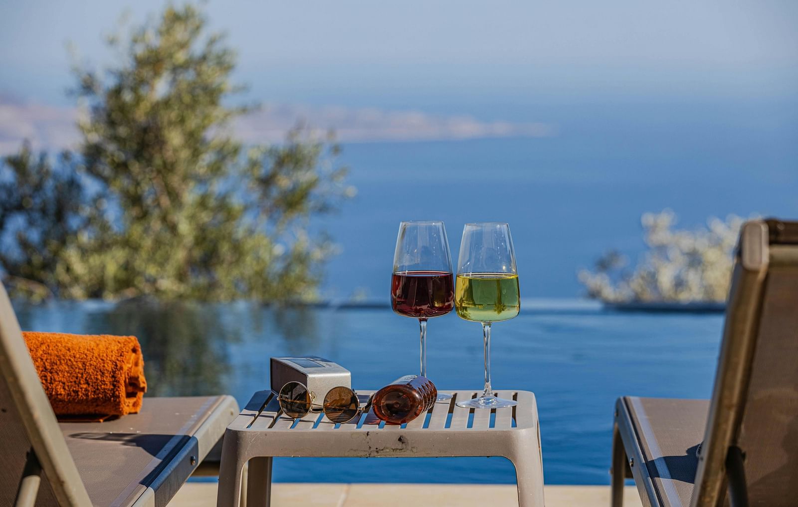 An image of two drinks placed on a coffee table and two lounge chairs overlooking the sea - Hotel 39, Jamaica
