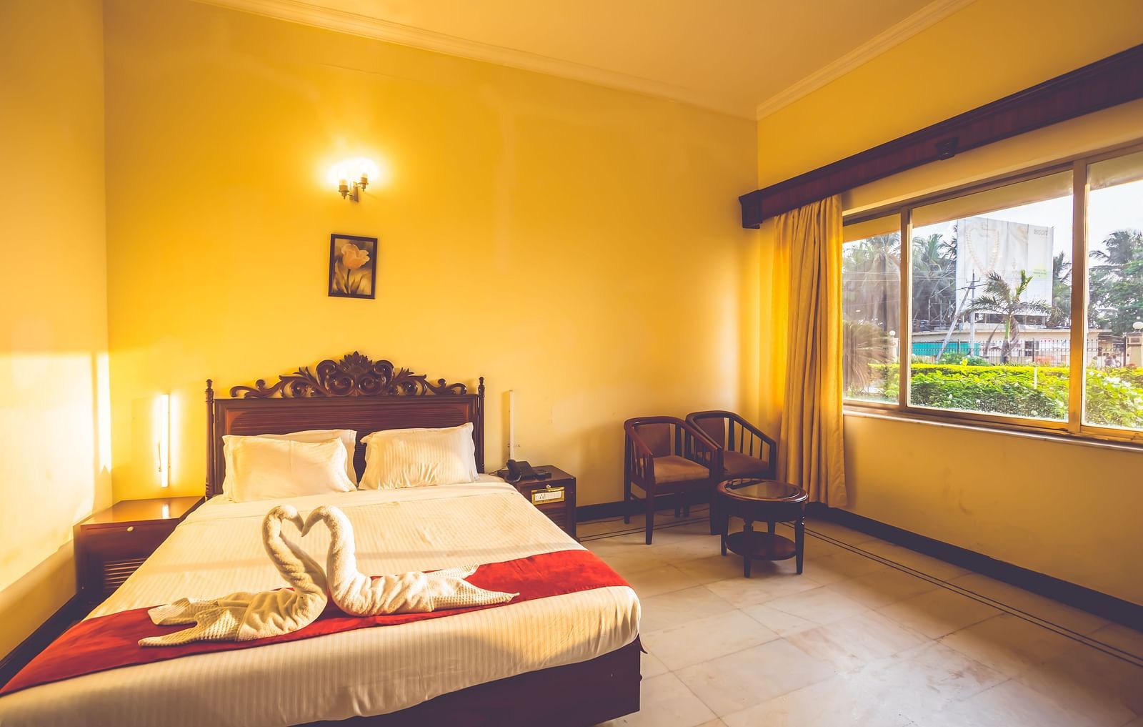 Premium Room at Paradise Isle Beach Resort, Udupi with a double bed and garden views from the window