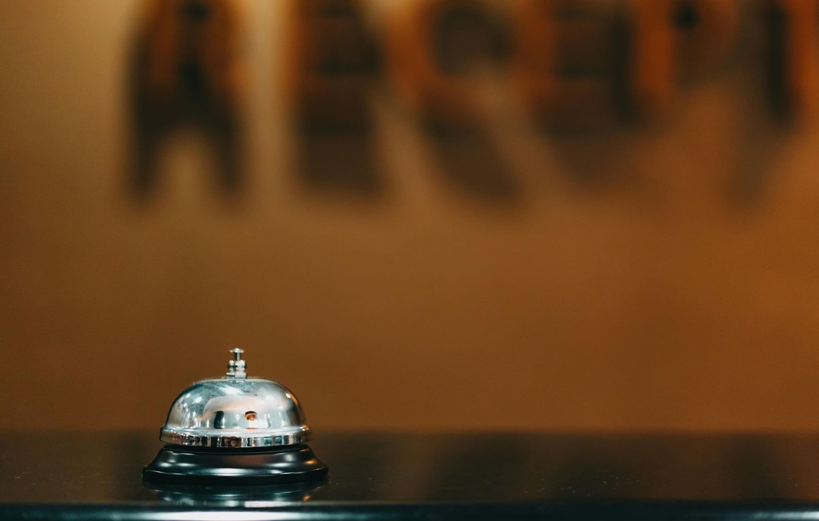 Image of a concierge bell kept on the table.