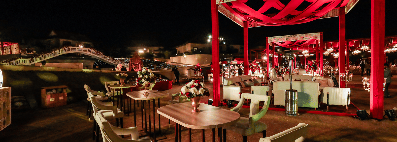 An outdoor dining area with tables chairs and an open structure at Ananta Spa and Resort, Jaipur