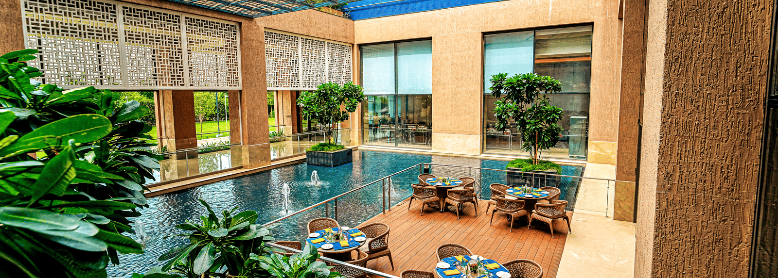 A stunning outdoor dining area with water features and natural light, creating a tranquil dining experience - Grand Madurai by GRT Hotels