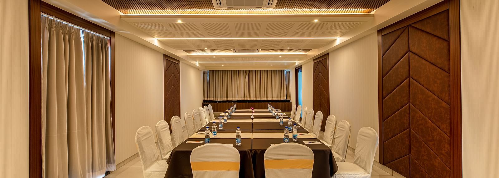 Image of a boardroom featuring a table surrounded by chairs at M Pro Palace.