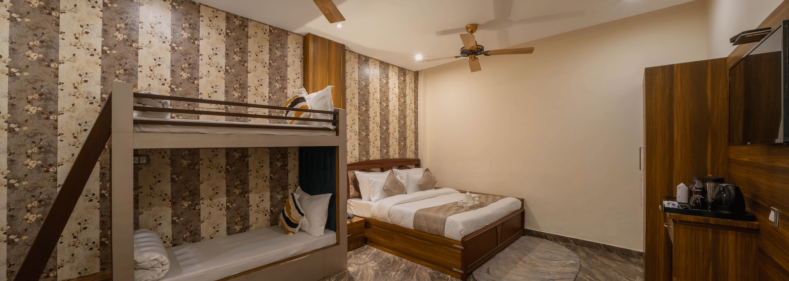 Hotel room view featuring a double bed, bunk beds, and a ceiling fan - Perfectstayz Premium at Har Ki Pauri Road (Ganga Heights)