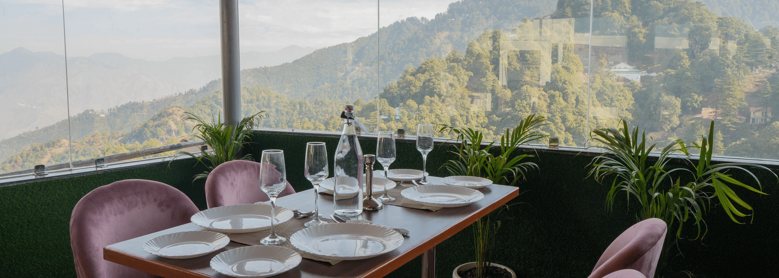 A dining setup with chairs and table facing mountain view at Perfectstayz Premium at Mall Road Hotel Super, Mussoorie.