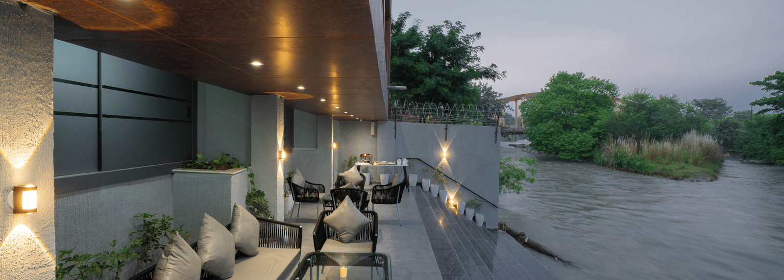 Comfortable outdoor seating area overlooking the river, perfect for relaxing at Sukoon by the Ganges.