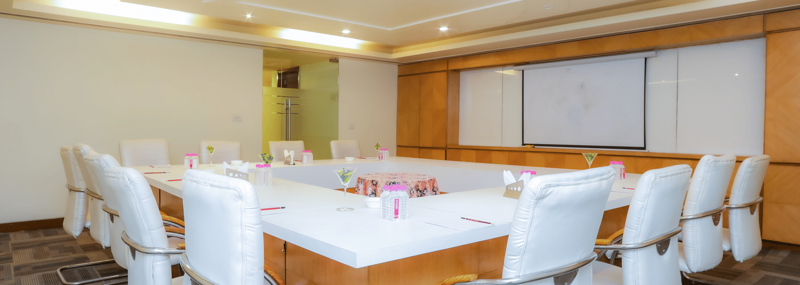 A well-arranged conference room with a large table and ergonomic chairs, ideal for business at The Conway, Meerut.