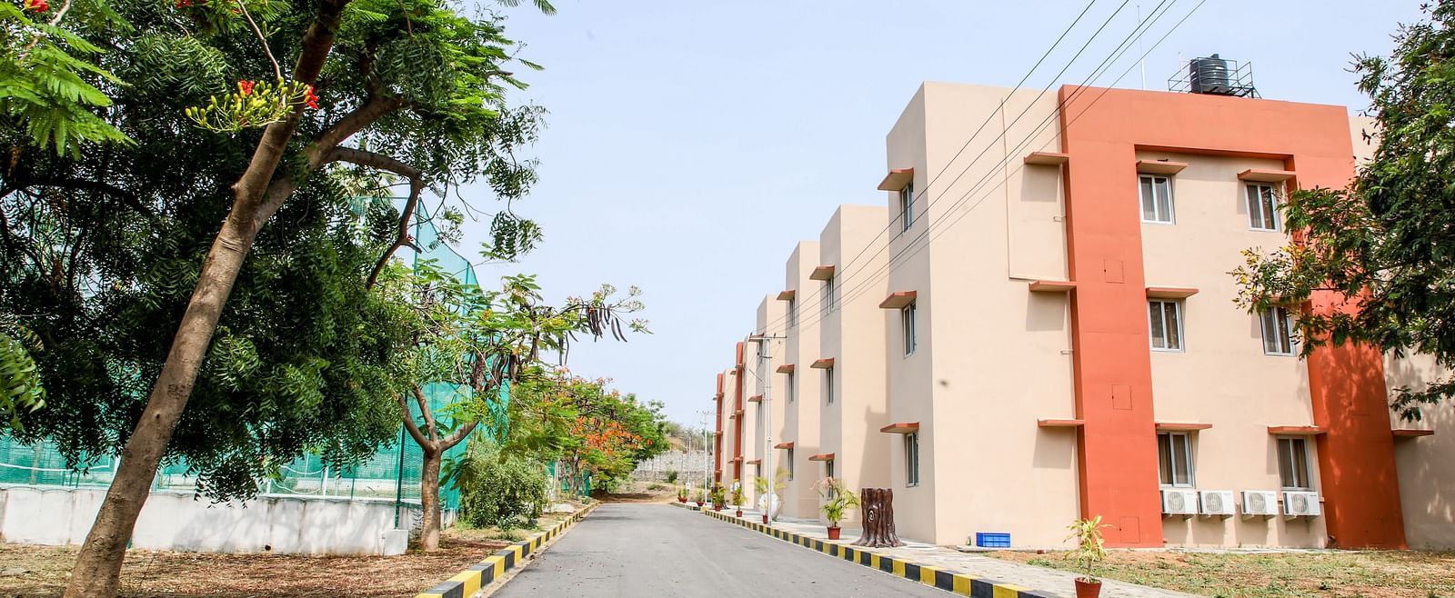 A different angle of aA different angle of a hotel facade, showcasing the clean lines of the building and the landscaped street at Greens Inn - Comfortable Stay in Hyderabad. hotel facade, showcasing the clean lines of the building and the landscaped stree
