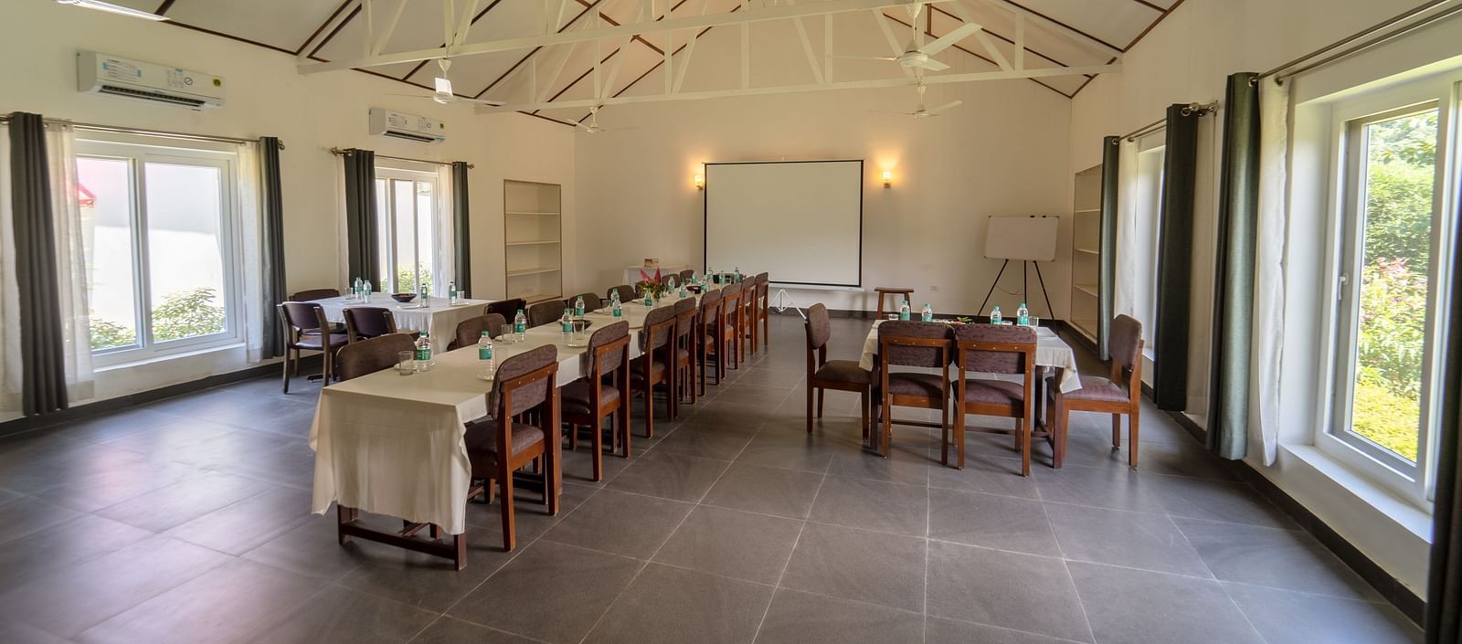 Conference hall with chairs and tables at Neer Ganga Resorts