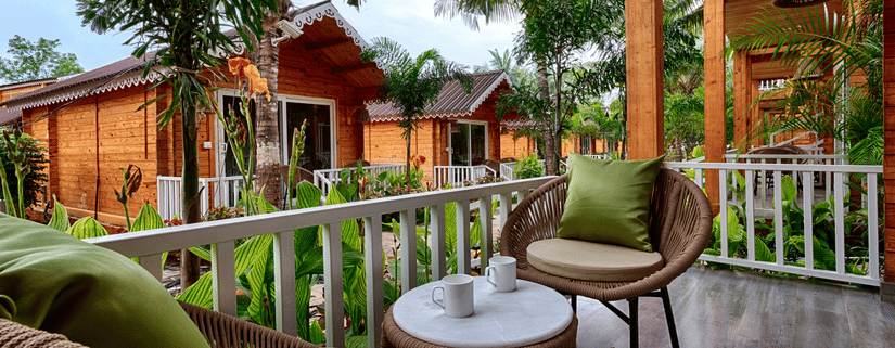 Outdoor seating area surrounded by greenery at Aralea Beach Resort by Stone Wood, Morjim