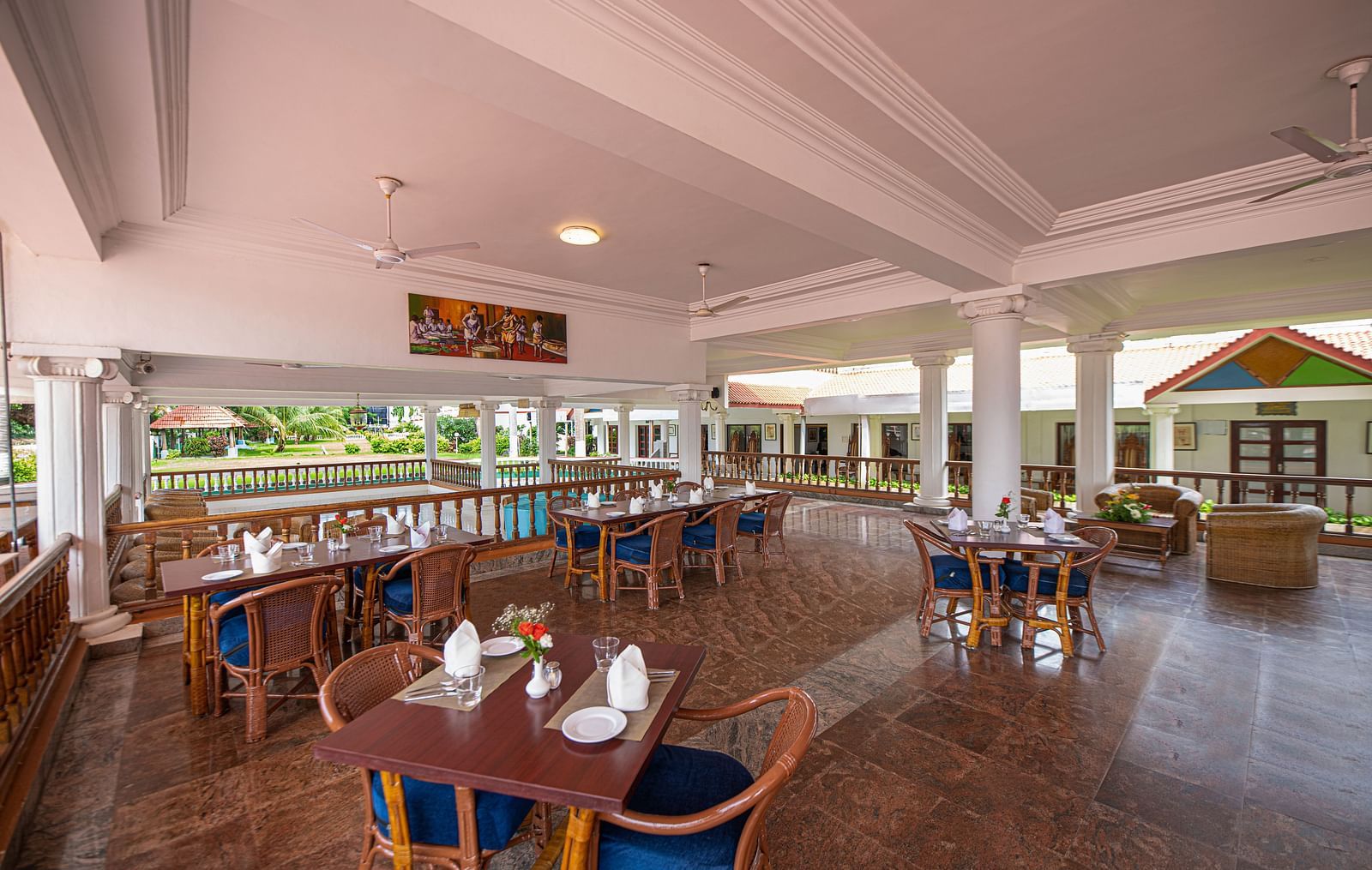 An image of the outdoor dining area featuring tables and chair at GReaT Trails River View Resort Thanjavur By GRT Hotels