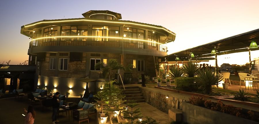 alt-text outdoor dining at dusk - Polo Orchid Resort, Cherrapunji