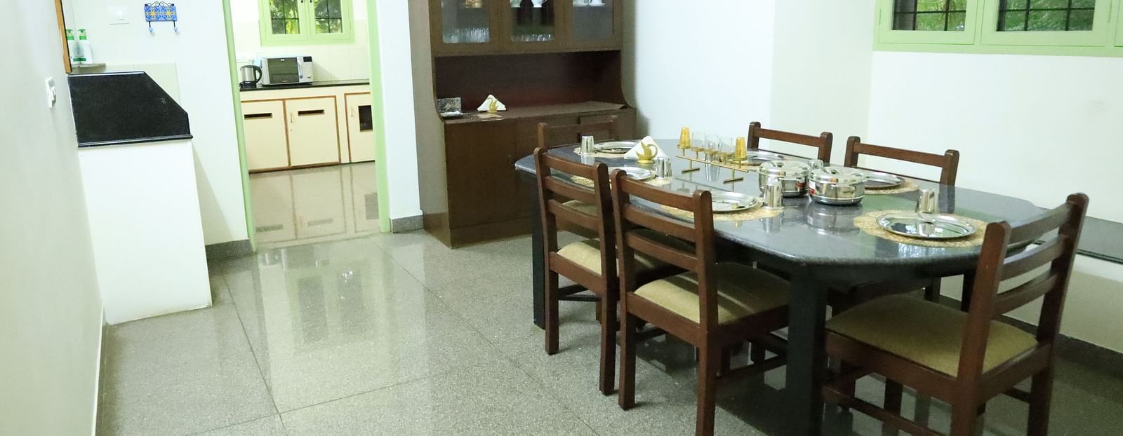 Image of the dining room with a table, chairs, and a cabinet.