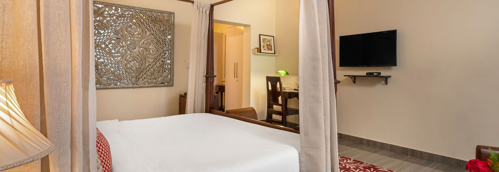Comfortable suite with elegant furnishings, canopy bed, and flat-screen TV, at BluSalzz Collection - Suvaasa Resort, Ramgarh.