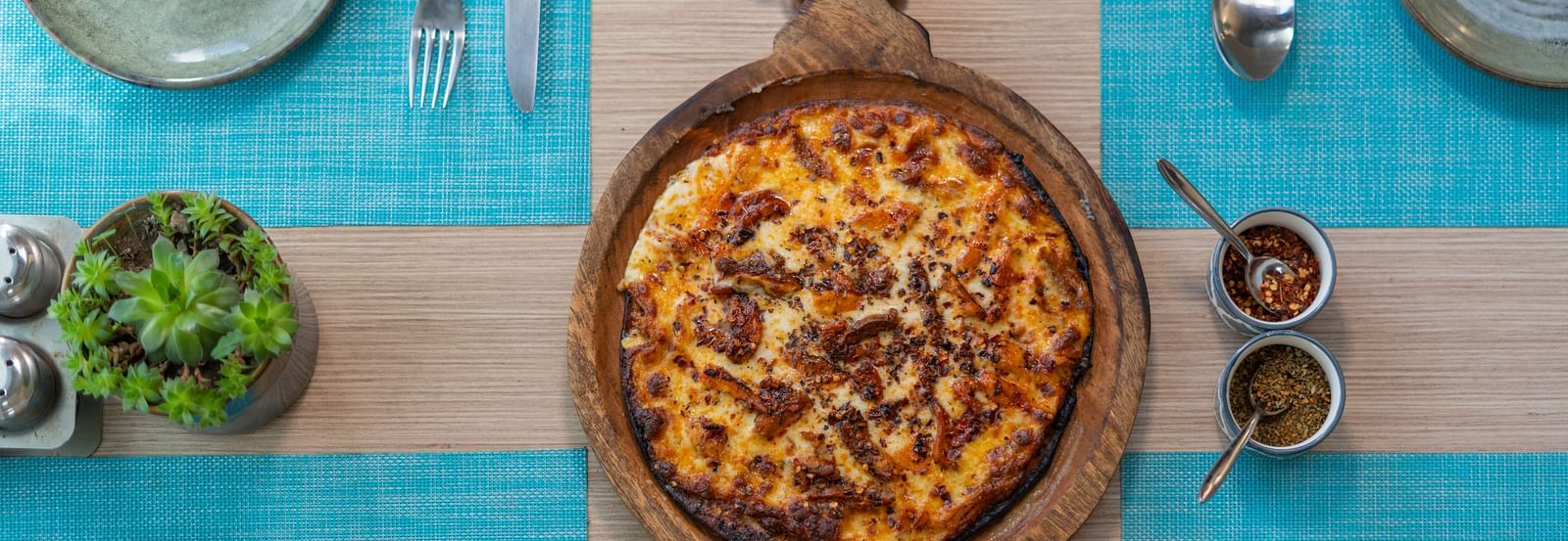A fresh pizza served hot with toppings at BluSalzz Escapade Resort, Lansdowne.