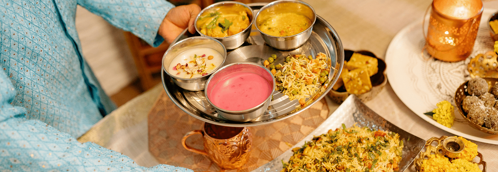 A traditional Indian thali meal, with a variety of vibrant dishes served in metal bowls.