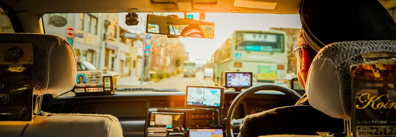 A backseat view of a person driving the car.
