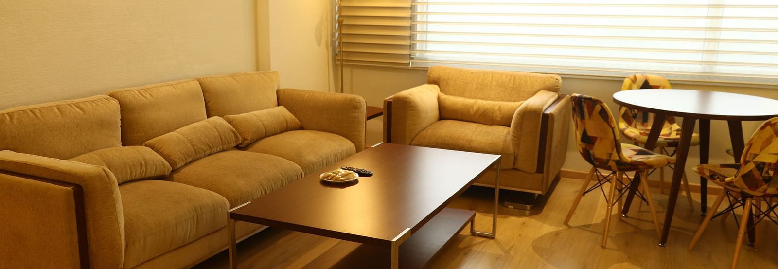 A living area featuring a sofa set, coffee table, and dining setup | Gemini Continental