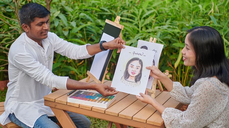  A person drawing a caricature of a woman on a piece of paper at The Dukes Retreat