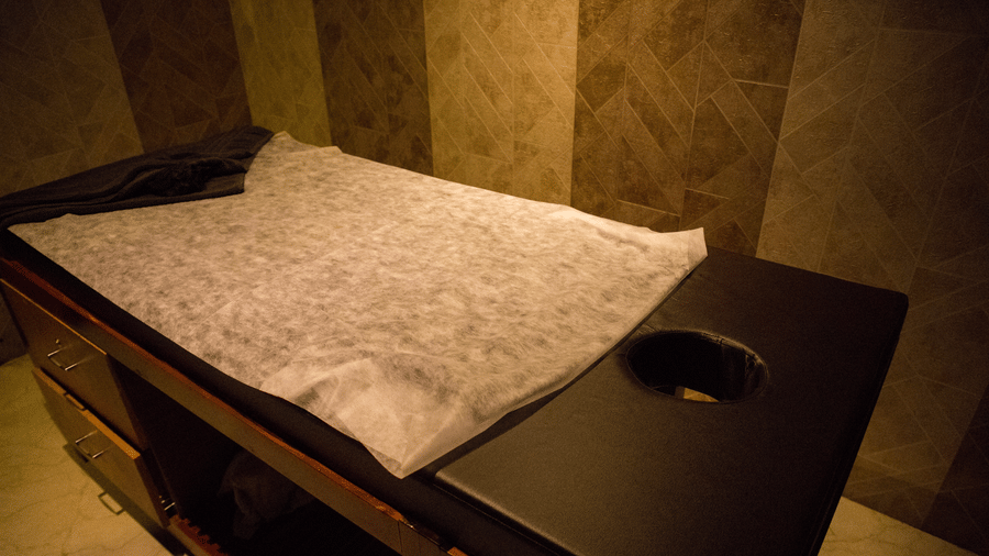 Close up of the spa bed at the Benzzee O2 Spa at the Benzz Park, Vellore, featuring a towel spread over it.